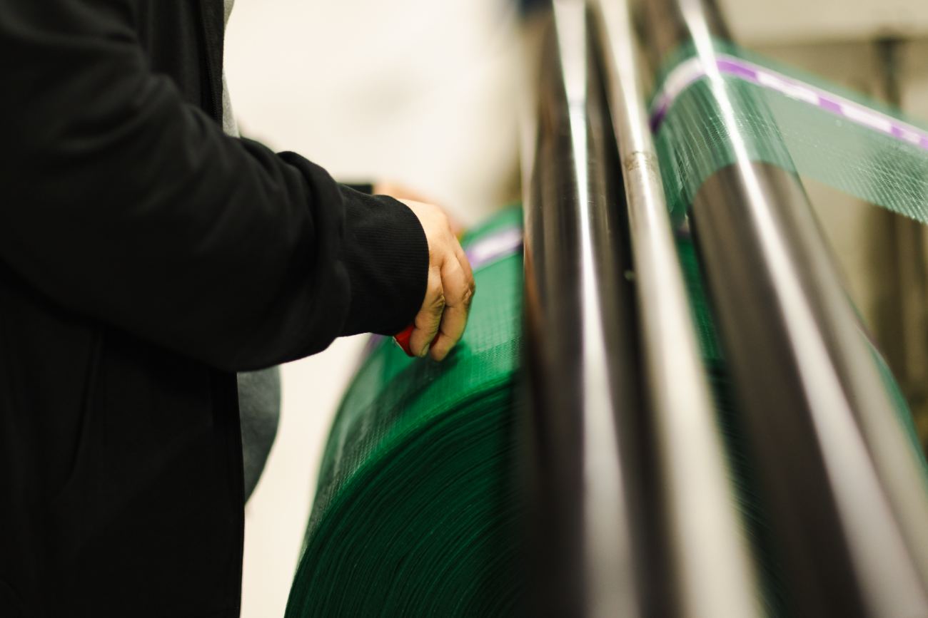 Operator handling produce packaging on the press
